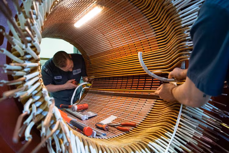 Technicians servicing a large industrial motor